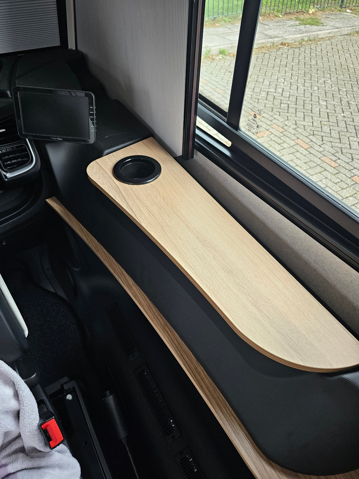 Pilote A class armrest flap with cup holder, fitted in the cab