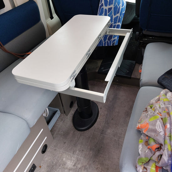 Light grey folding table top fitted in a Chausson X550, clearing the slide out frame
