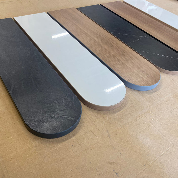Made to measure edgebanded motorhome shelves in black, white, oak and marble laminates, laid out in the workshop