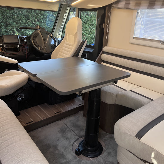 Custom folding table top fitted in a motorhome, on a single table leg